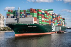 Green cargo ship on water representing shipping services near Utah by Mane Shipping for reliable delivery solutions.