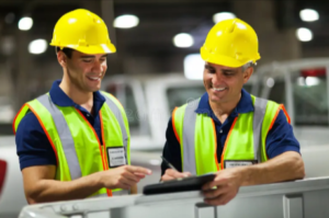 Workers using tablets for USPS shipping services in Utah operations by the Mane Shipping team's professional logistics